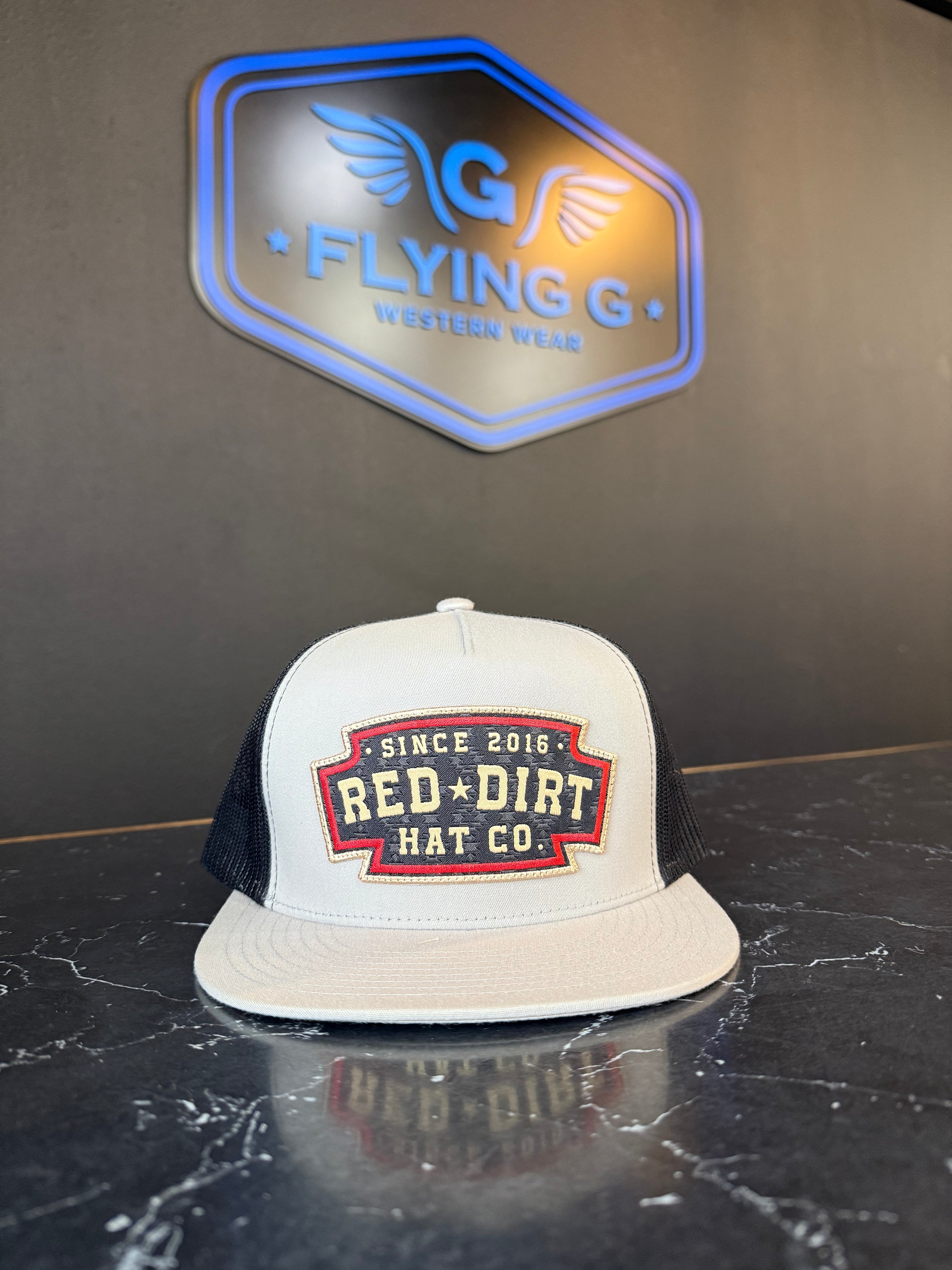Light grey and black with red logo red dirt cap