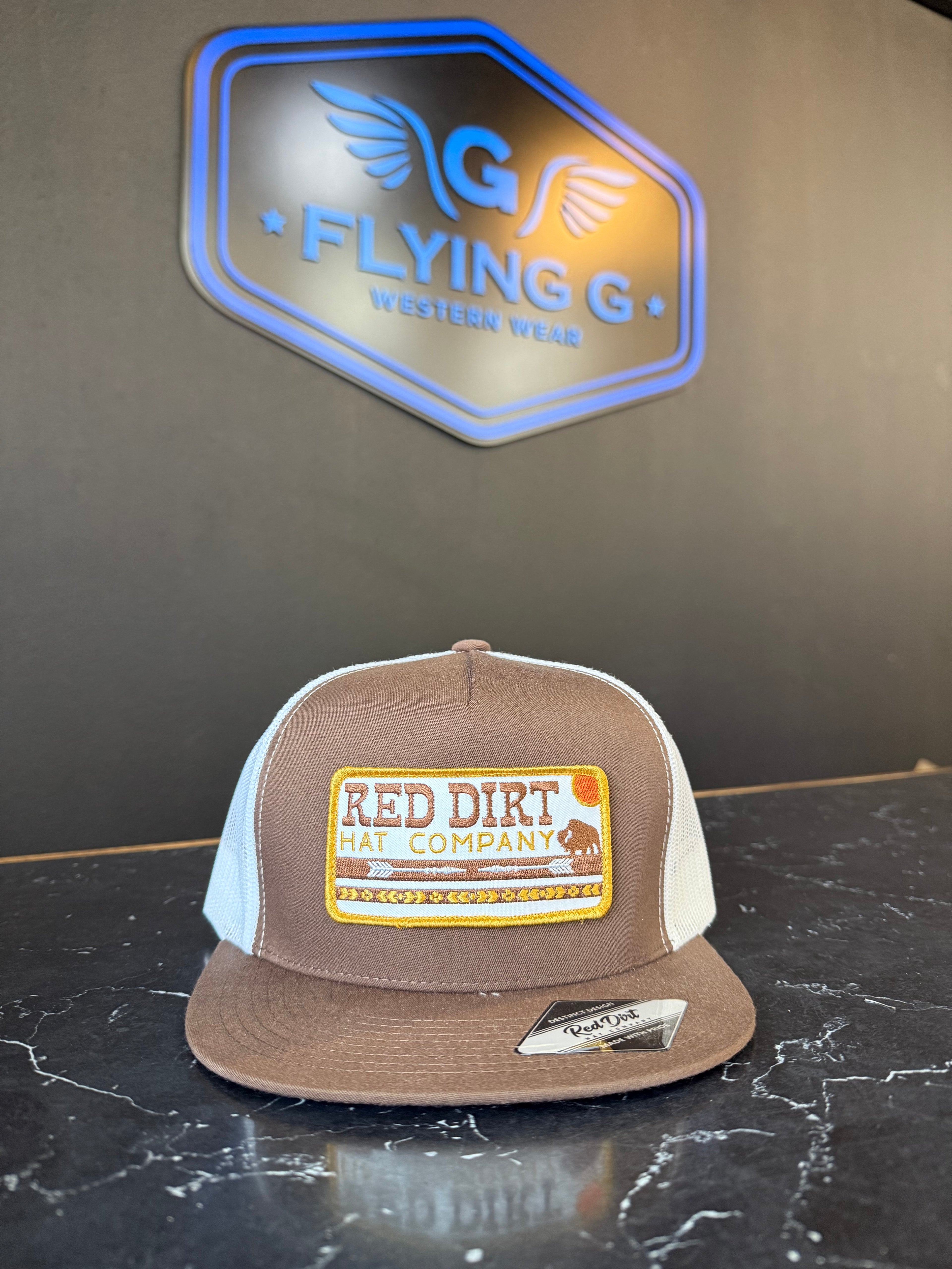 Brown and white red dirt cap