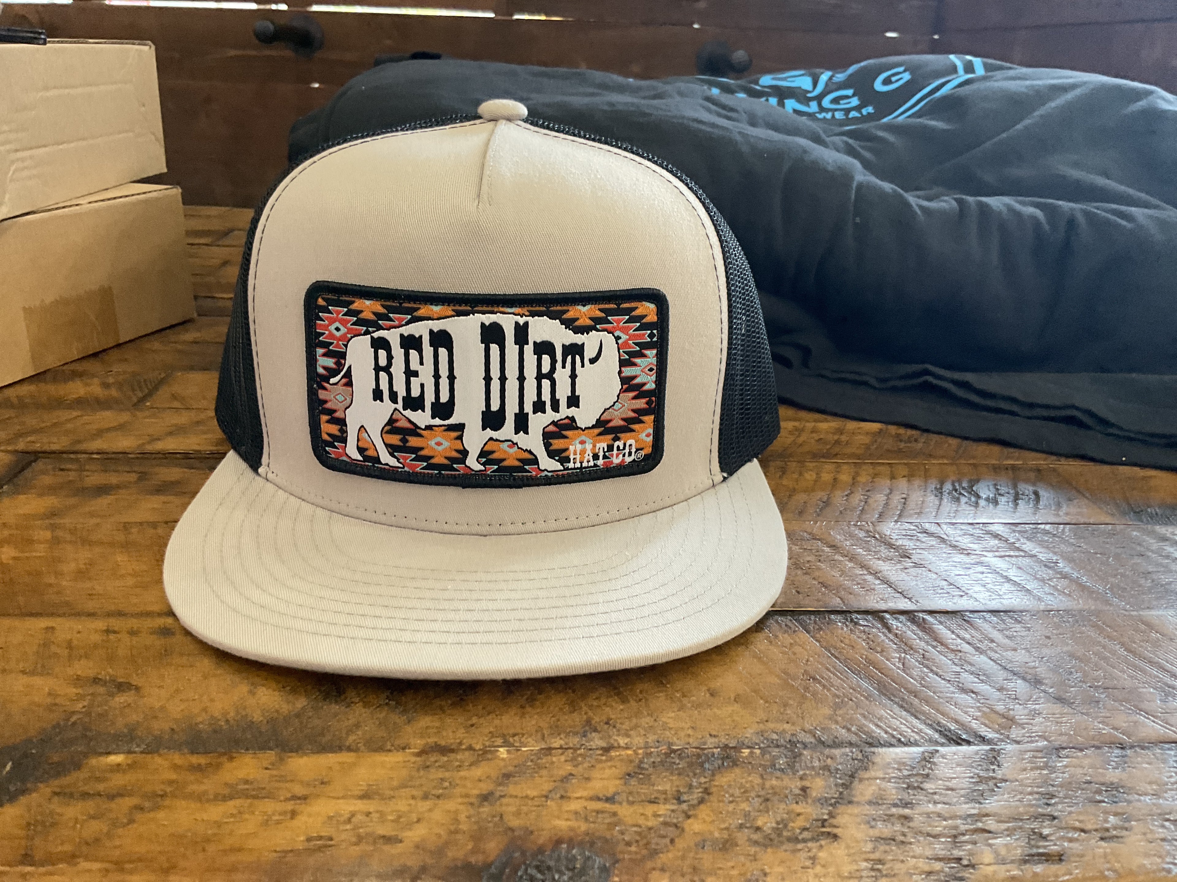 Tanish grey and black red dirt buffalo cap